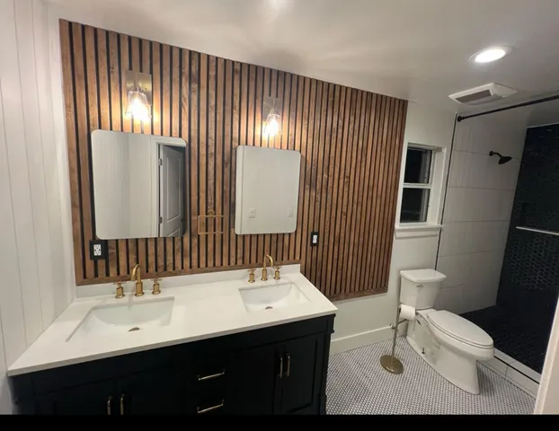 a bathroom with a double vanity sink and mirror