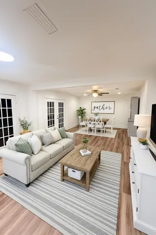 a living room with furniture and a large window