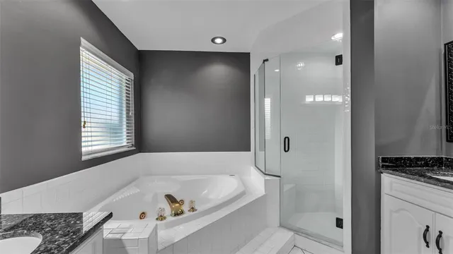a bathroom with a glass shower door
