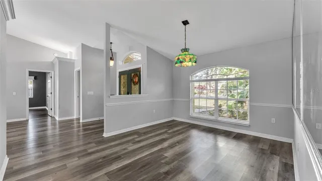 a kitchen with granite countertop white cabinets and white stainless steel appliances
