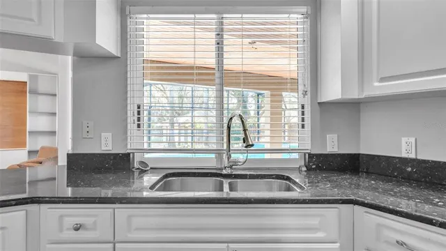 a living room with furniture and kitchen view