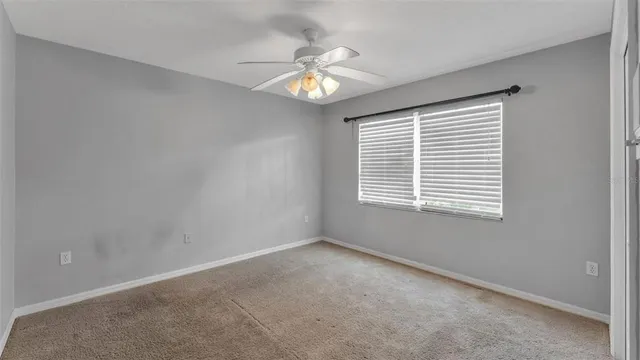 a view of a chandelier fan and entryway