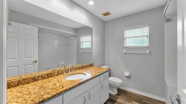 a bathroom with a glass shower door