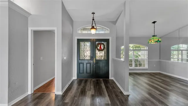 a view of an entryway with wooden floor