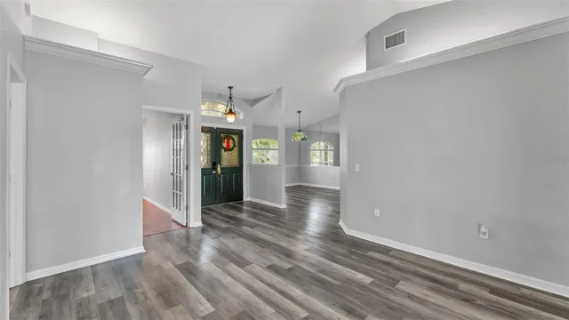 a view of a hallway with wooden floor