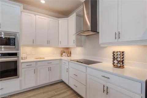 a kitchen with white cabinets and white appliances
