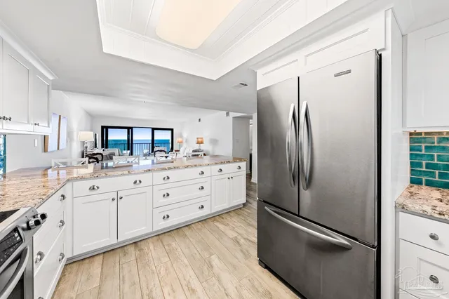 a kitchen with a refrigerator stove and sink