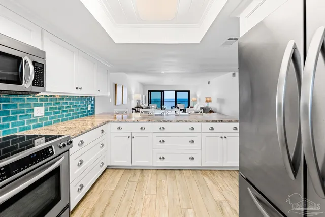 a view of a living room with furniture and a wooden floor