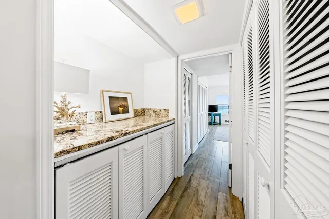 a bathroom with a granite countertop sink a toilet and shower