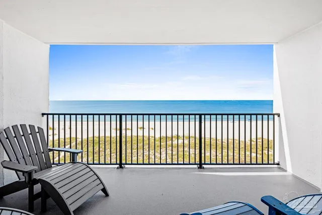 a balcony with chairs and wooden floor
