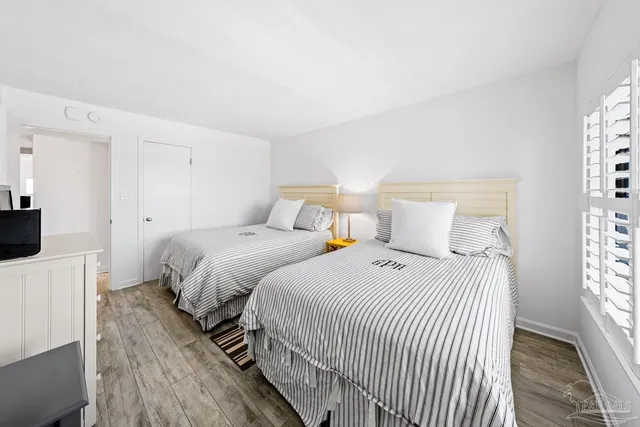 a view of a dining room with furniture large windows and wooden floor