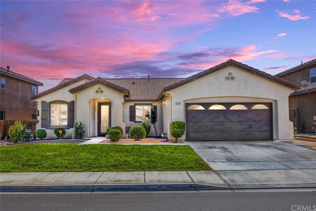 15091 Sorrel Road Victorville, CA 92394 - Photo 1 of 1 a front view of a house with a yard and garage
