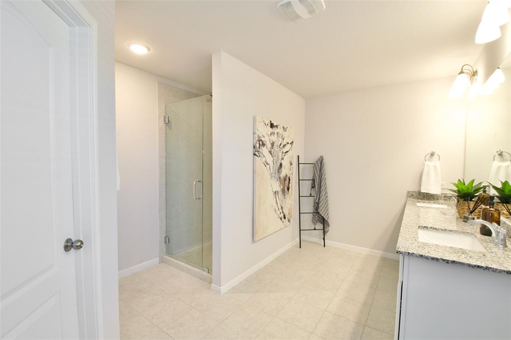 11229 Solar Street Lorena, TX 76655 - Photo 25 of 34 Bathroom with double vanity, a shower stall, and light tile patterned flooring