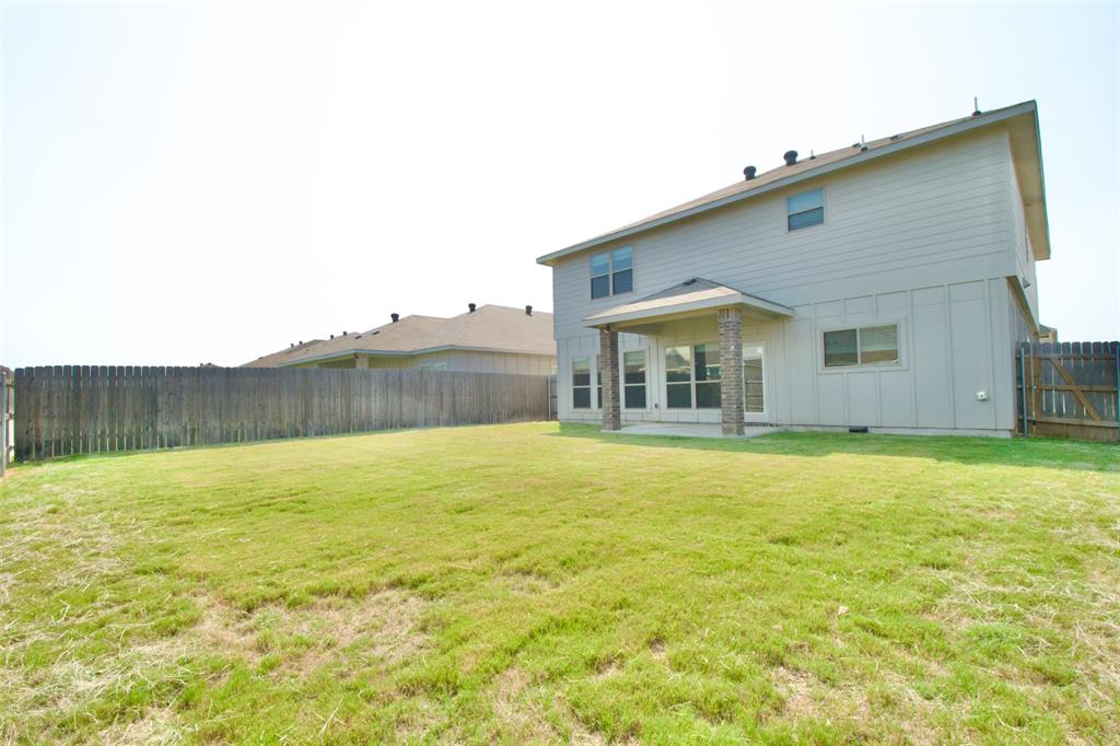 11229 Solar Street Lorena, TX 76655 - Photo 33 of 34 Rear view of house featuring board and batten siding and a fenced backyard