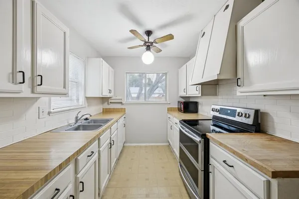 a kitchen with a stove a sink and a refrigerator