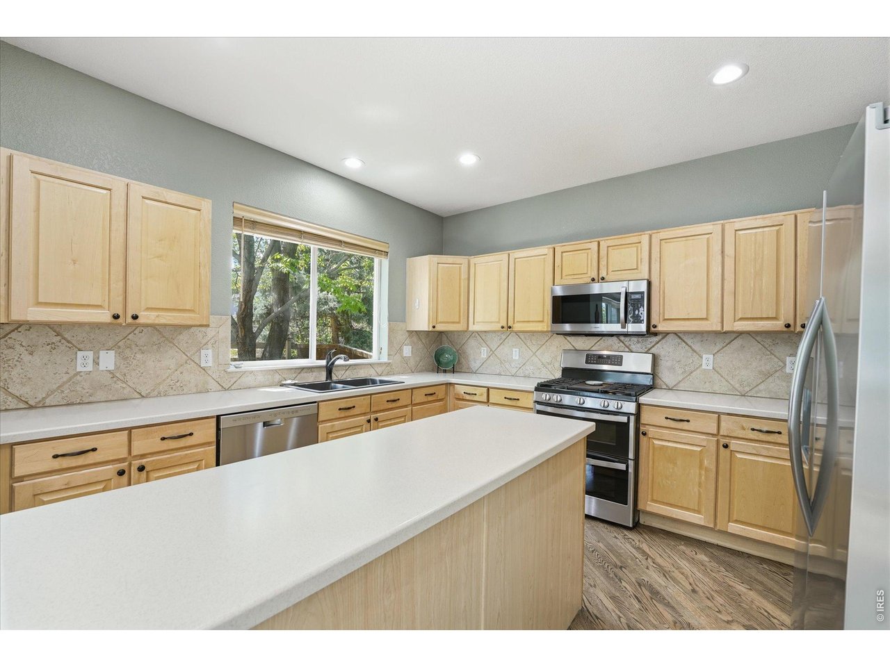 651 Americana Road Longmont, CO 80504 - Photo 8 of 50 Fully updated stainless appliances, maple cabinetry, Corian counterops and huge center island