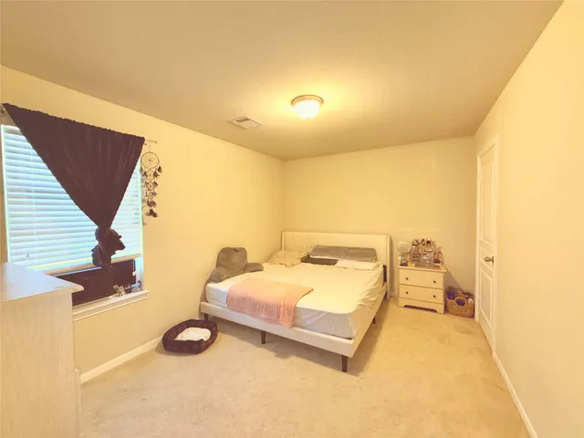 a bedroom with a bed and a night stand