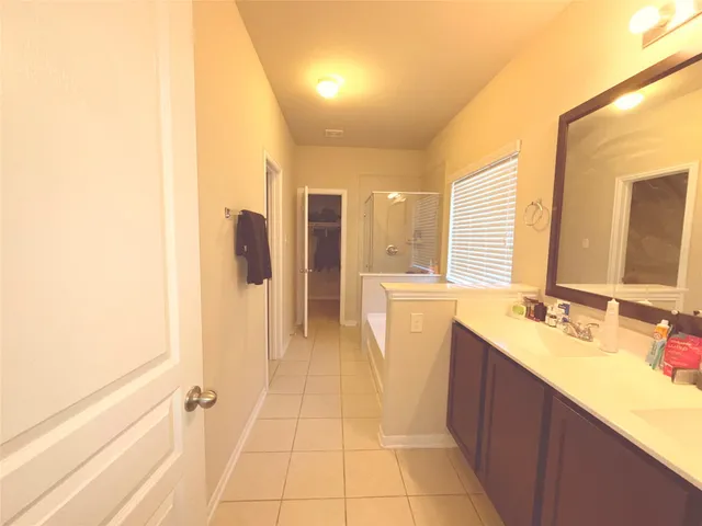 a bathroom with a sink a mirror and a shower