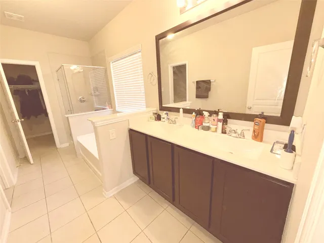 a bathroom with a double vanity sink a mirror and a