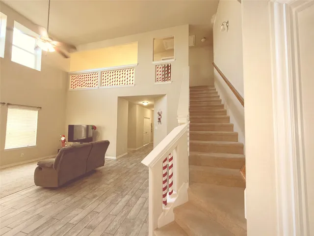 a living room with furniture and a stairs