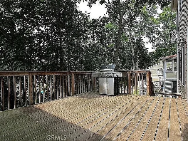 a view of a deck with wooden floor and fence