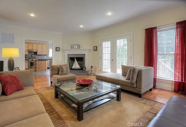 a living room with furniture fireplace and a large window