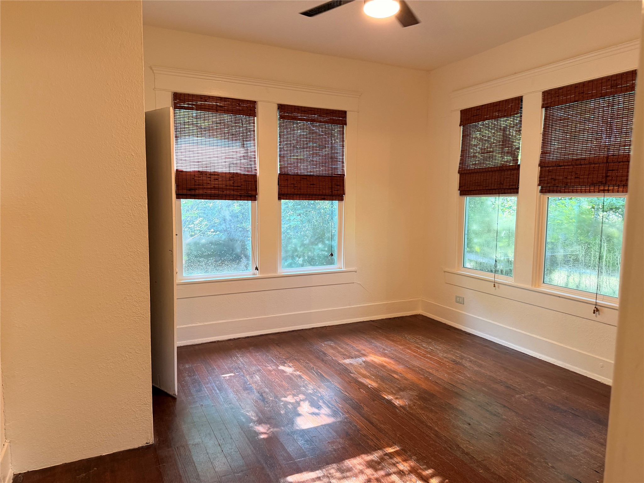 1136 Eleanor Street Austin, TX 78721 - Photo 13 of 30 Hardwood floors and bright windows create an inviting atmosphere in this versatile space.