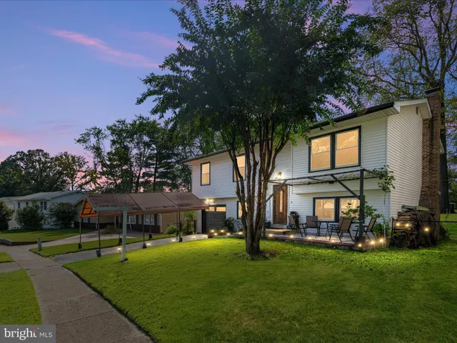 a view of house with outdoor space and garden