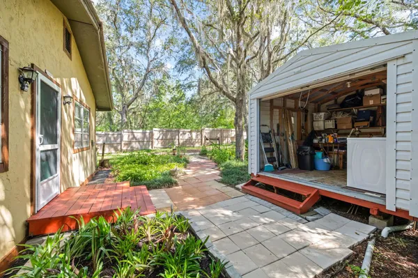 a backyard of a house with barbeque oven table and chairs