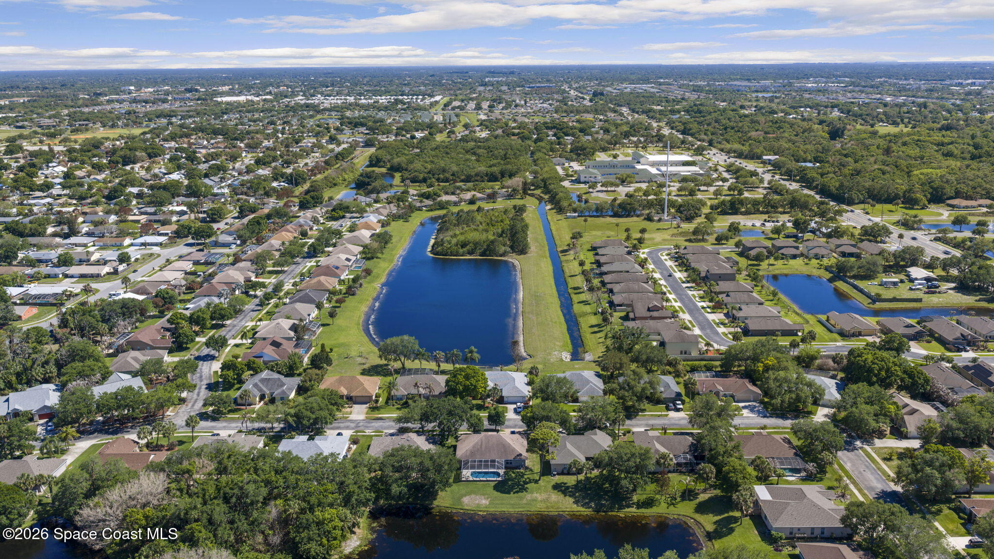 1123 Spring Oak Drive Melbourne, FL 32901 - Photo 63 of 67 an aerial view of residential houses with outdoor space and trees