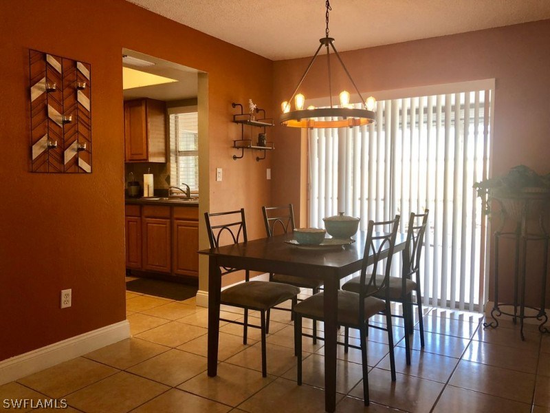 7361 Pebble Beach Road Fort Myers, FL 33967 - Photo 4 of 14 a view of a dining room with furniture and chandelier