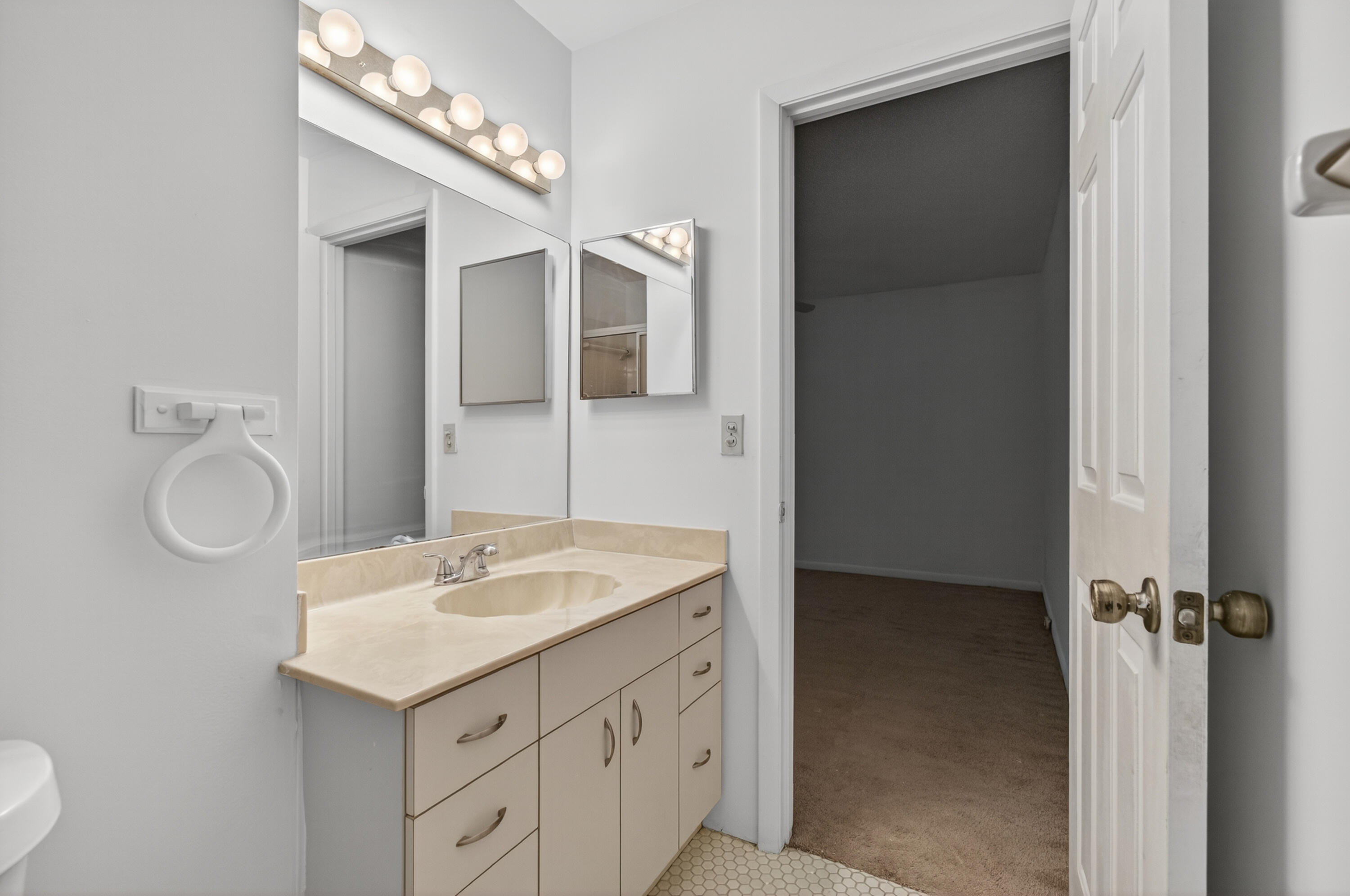 3939 Northeast 5th Avenue, Unit C203 Boca Raton, FL 33431 - Photo 12 of 30 a bathroom with a sink and a mirror
