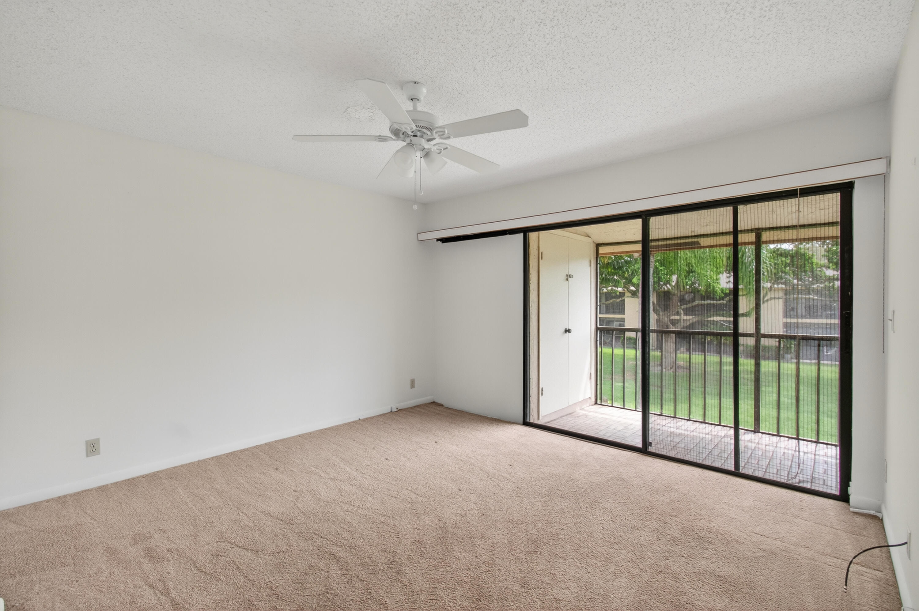 3939 Northeast 5th Avenue, Unit C203 Boca Raton, FL 33431 - Photo 13 of 30 a view of an empty room with sliding glass door
