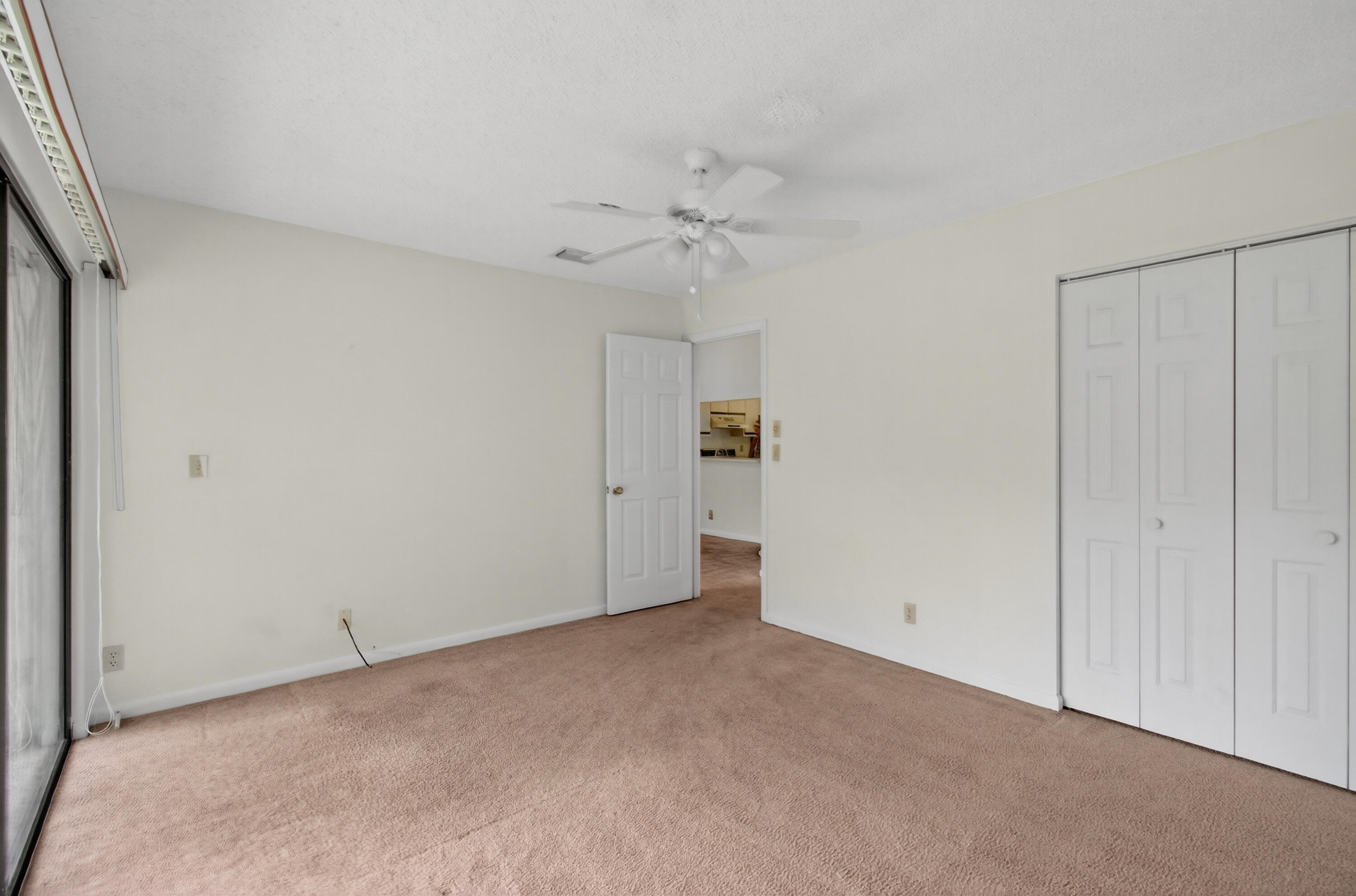 3939 Northeast 5th Avenue, Unit C203 Boca Raton, FL 33431 - Photo 15 of 30 a view of an empty room with a ceiling fan