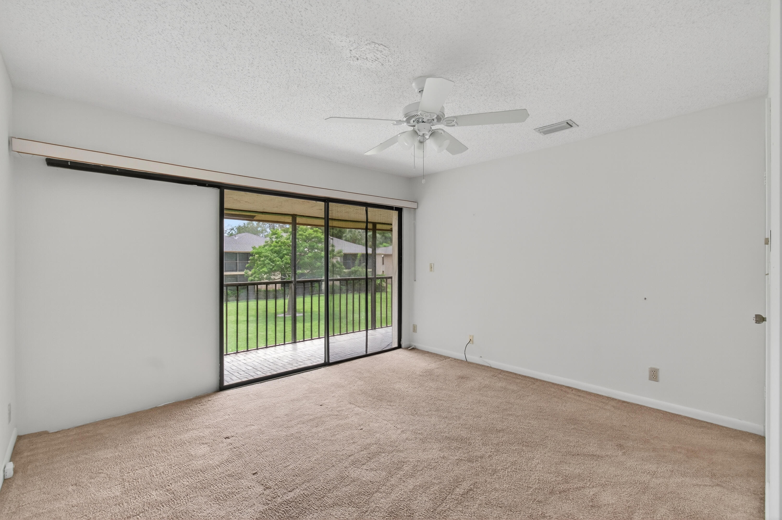 3939 Northeast 5th Avenue, Unit C203 Boca Raton, FL 33431 - Photo 16 of 30 a view of a livingroom with a ceiling fan and window