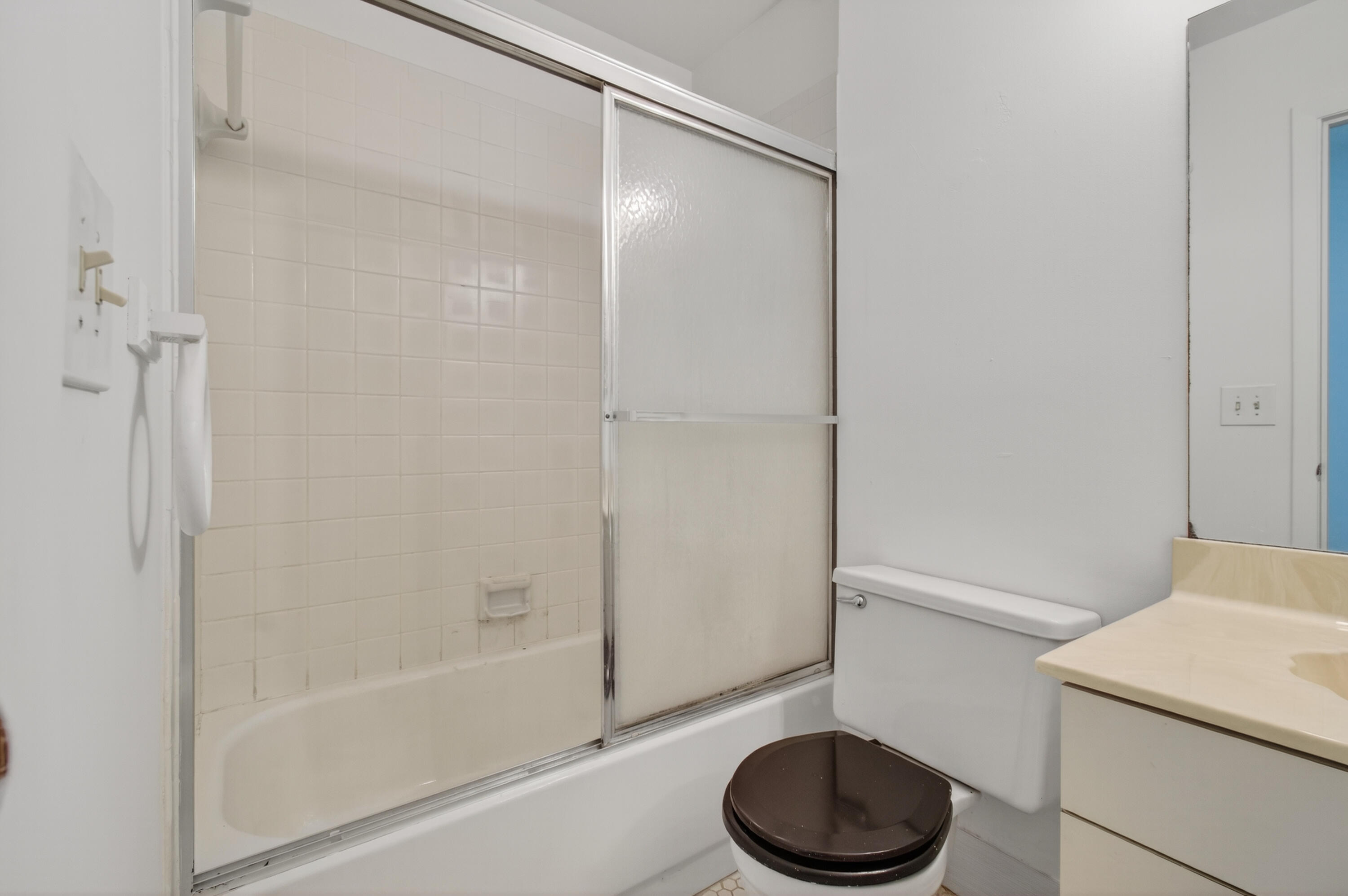 3939 Northeast 5th Avenue, Unit C203 Boca Raton, FL 33431 - Photo 18 of 30 a bathroom with a toilet a sink and a shower