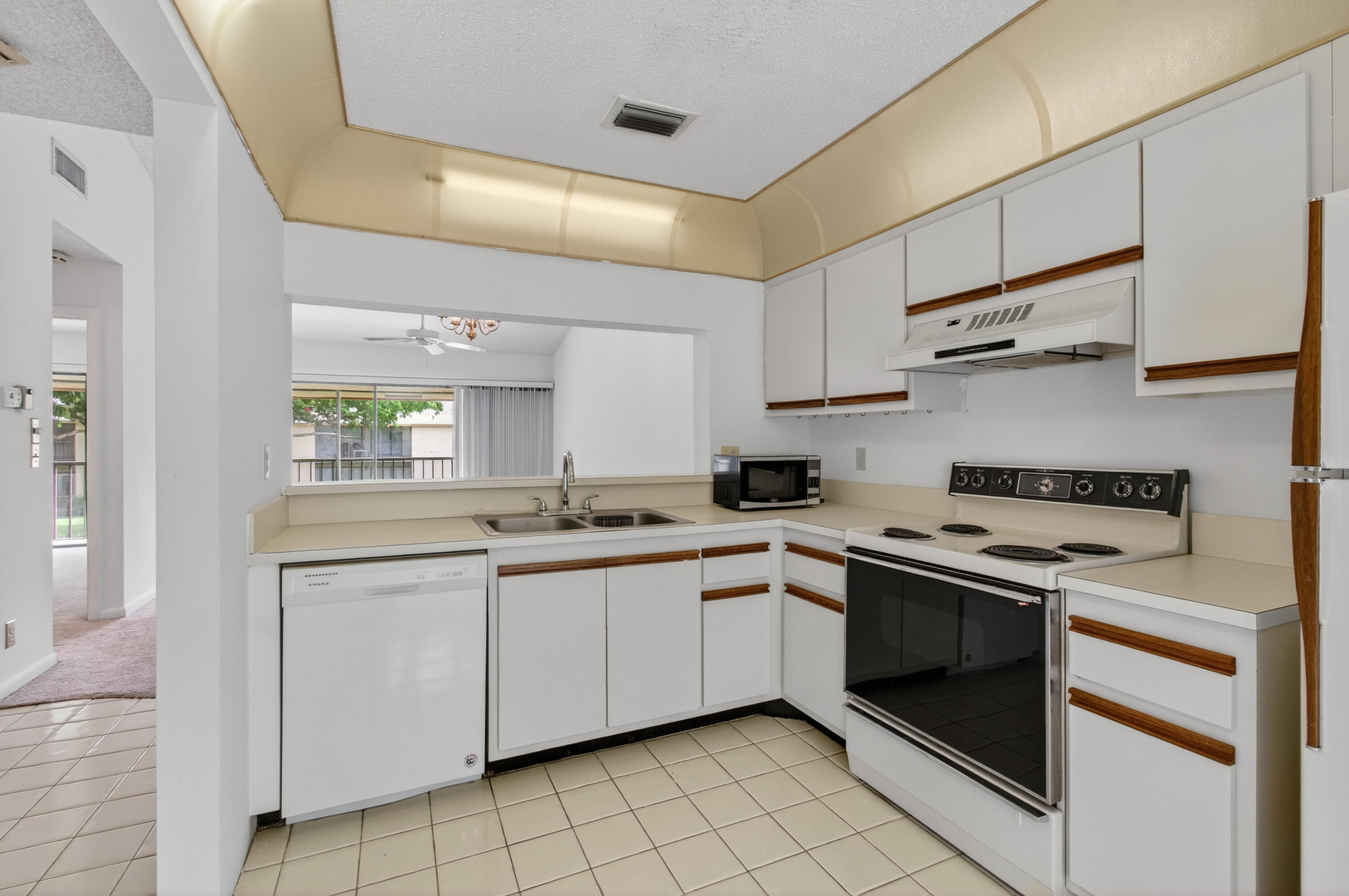 3939 Northeast 5th Avenue, Unit C203 Boca Raton, FL 33431 - Photo 2 of 30 a kitchen with stainless steel appliances granite countertop a sink and cabinets