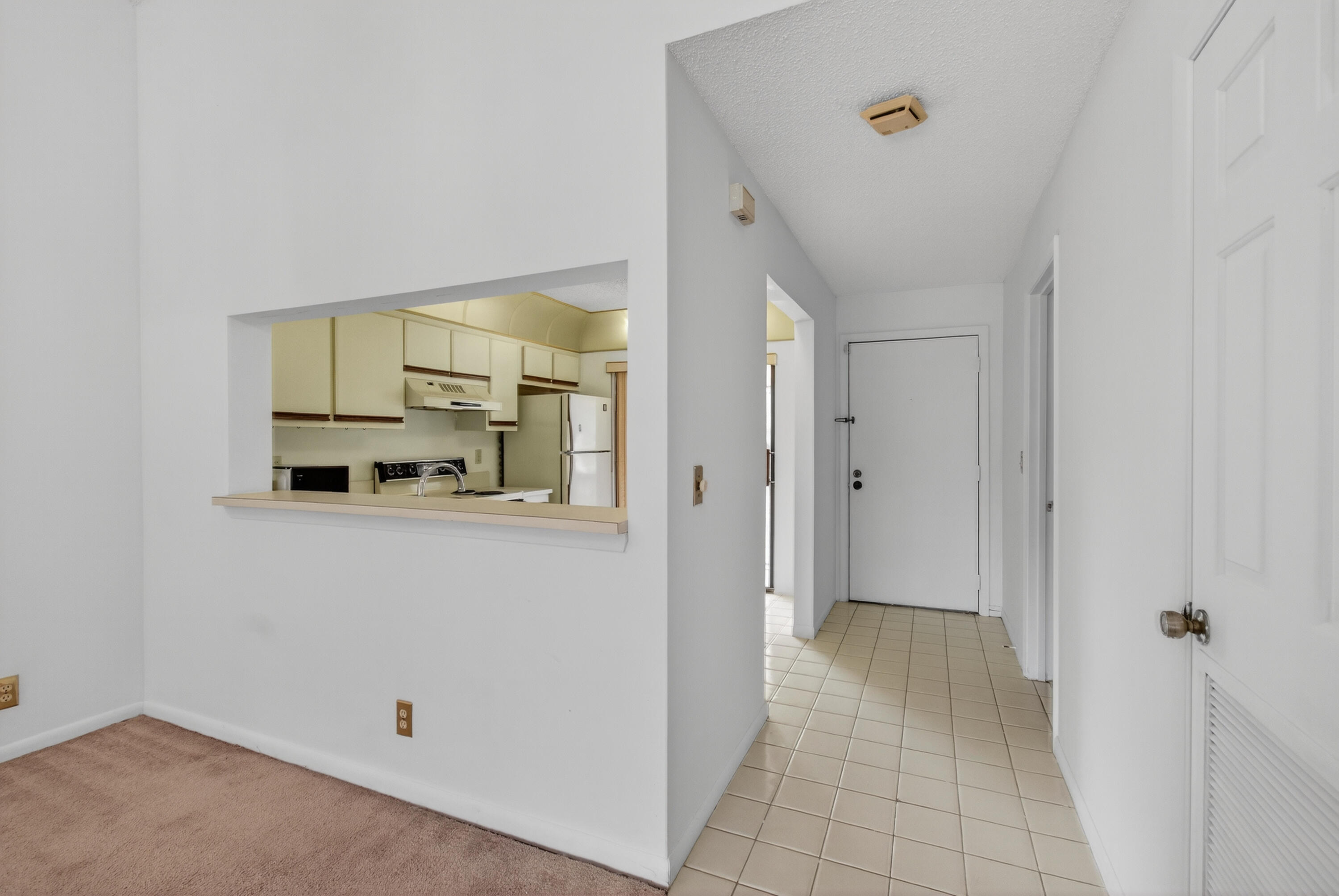 3939 Northeast 5th Avenue, Unit C203 Boca Raton, FL 33431 - Photo 23 of 30 a view of a hallway to a bedroom