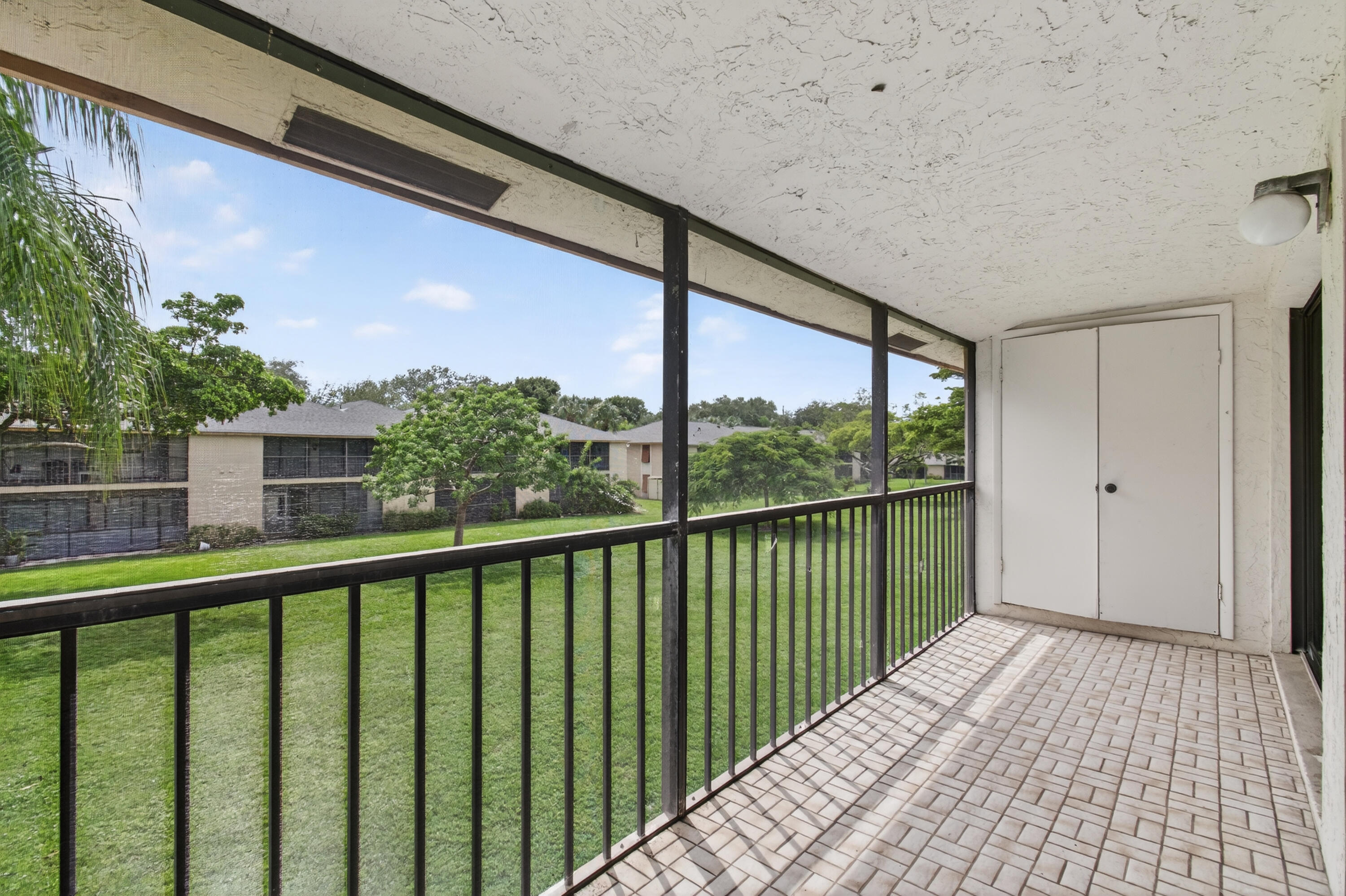 3939 Northeast 5th Avenue, Unit C203 Boca Raton, FL 33431 - Photo 25 of 30 a view of a balcony with wooden floor