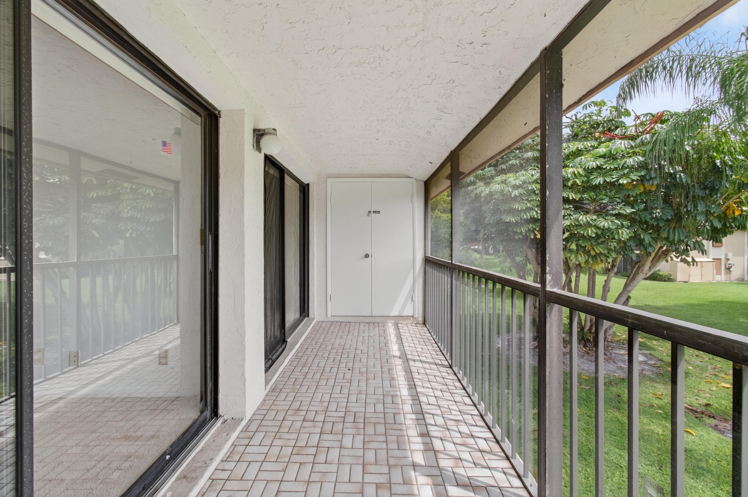 3939 Northeast 5th Avenue, Unit C203 Boca Raton, FL 33431 - Photo 28 of 30 a view of a balcony with wooden floor