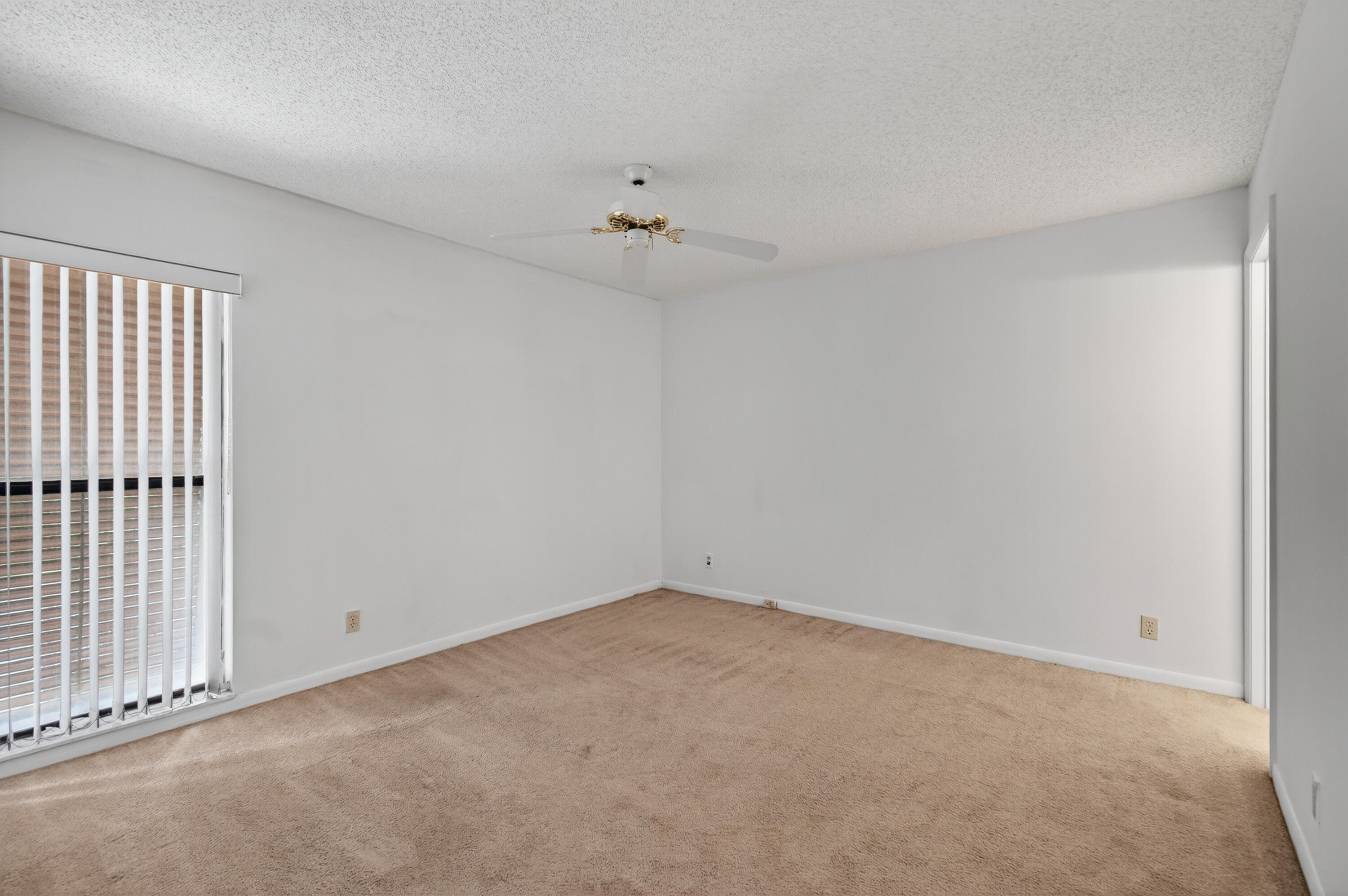 3939 Northeast 5th Avenue, Unit C203 Boca Raton, FL 33431 - Photo 6 of 30 an empty room with a ceiling fan and a window