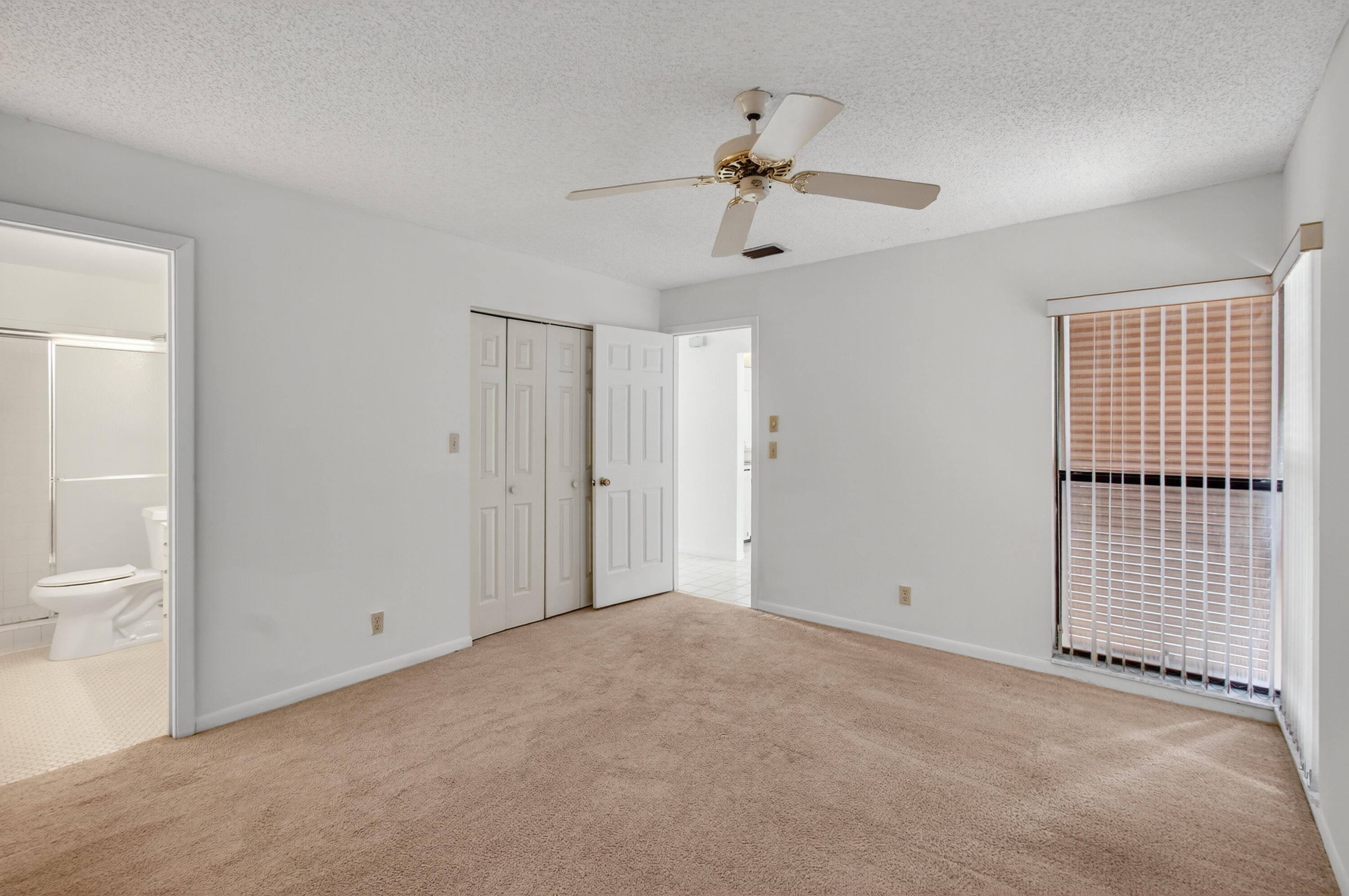 3939 Northeast 5th Avenue, Unit C203 Boca Raton, FL 33431 - Photo 8 of 30 a view of a livingroom with a ceiling fan and window
