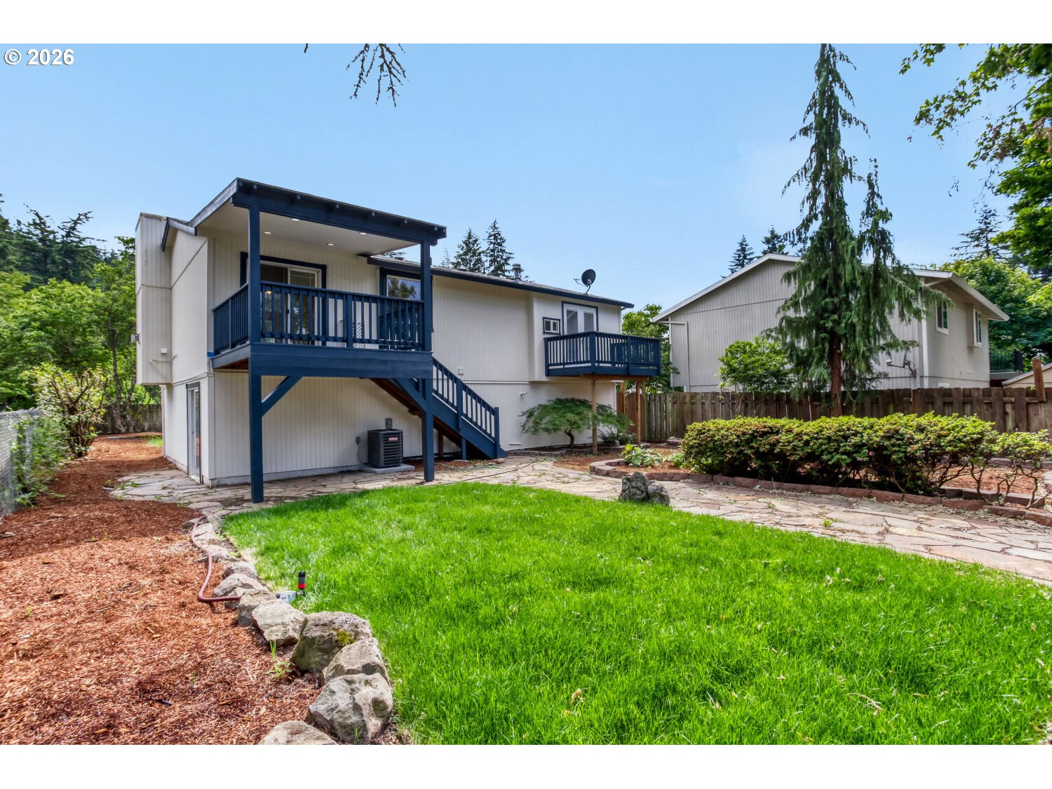 14539 Southeast Center Street Portland, OR 97236 - Photo 25 of 30 a view of a house with backyard sitting area and garden