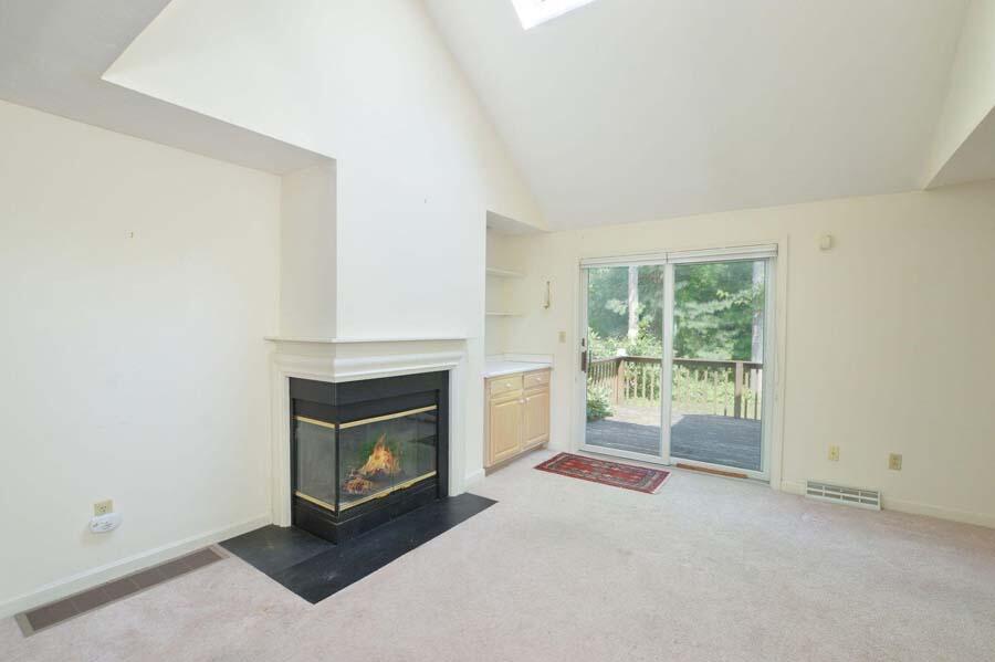 3 Kettle Lane Mashpee, MA 02649 - Photo 5 of 27 a living room with a fireplace and a floor to ceiling window