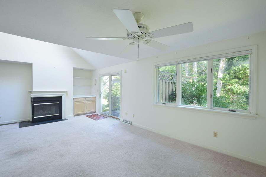 3 Kettle Lane Mashpee, MA 02649 - Photo 8 of 27 a view of an empty room with a fireplace and a window