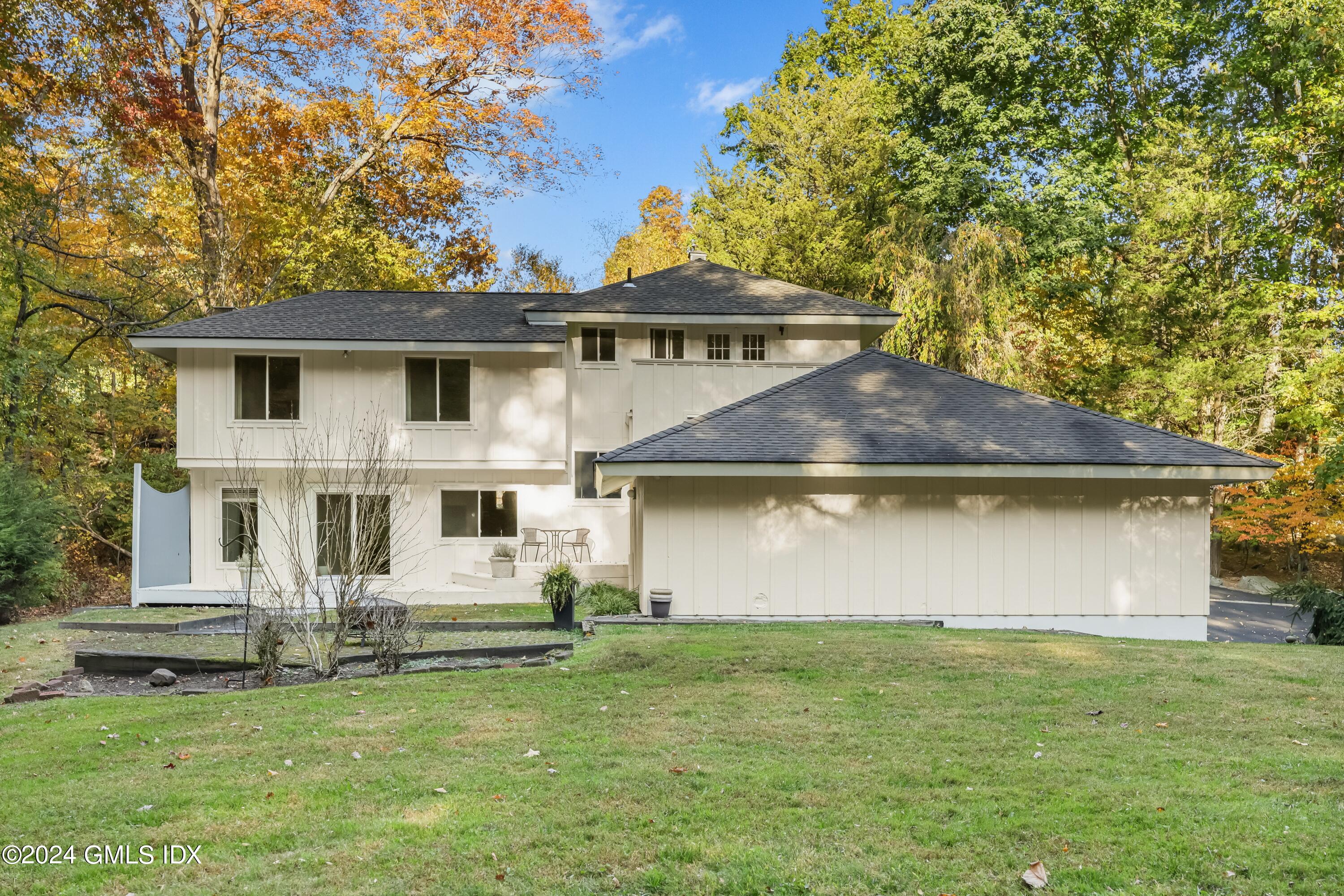 106 Akbar Road Stamford, CT 06902 - Photo 29 of 37 a front view of a house with a garden