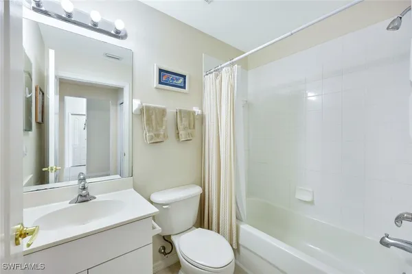 a bathroom with a sink toilet a mirror and shower