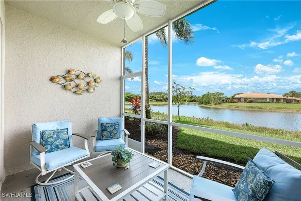 a view of a balcony with lake view and a potted plant