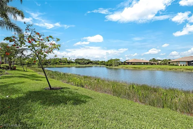 a view of a lake with houses in the back