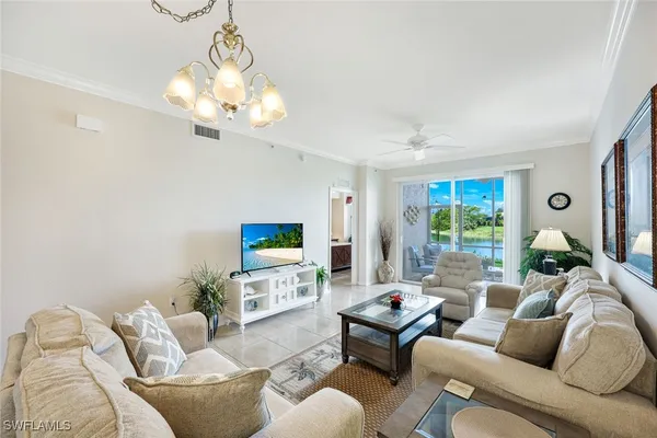 a living room with furniture a large window and a flat screen tv